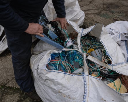 Green’s hands shove a last piece of plastic into a tangle of nets, lines and other detritus.