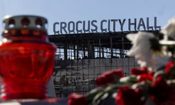 Candles and flowers are left outside Crocus City Hall in the Moscow region in tribute to those who died in the attack.
