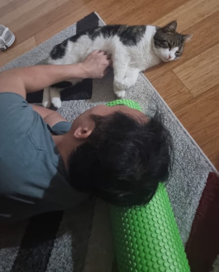 Hiep Tran playing with his cat.