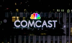 The NBC and Comcast logo are displayed on top of 30 Rockefeller Plaza in New York City. 