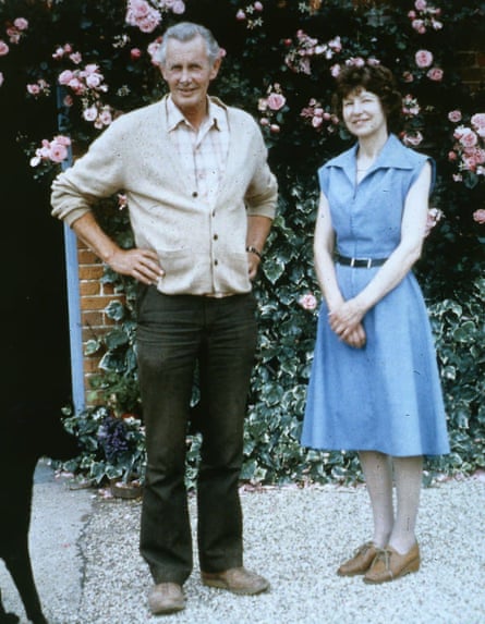 A picture of a man in black trousers and a cream top and a woman in blue dress
