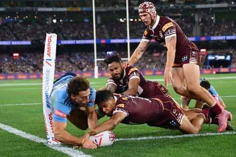 Mark Nawaqanitawase scores a try as three Maroons close in.