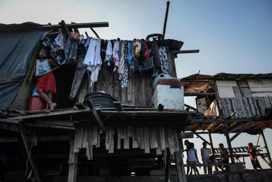 Makeshift houses along a breakwater in polluted Manila Bay, Philippines