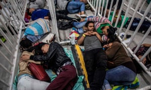 Venezuelan migrants living in Medellin, Colombia sleep as they wait to attend a job fair on 27 September. The United Nations reported that 2.6 million Venezuelans are now living abroad.