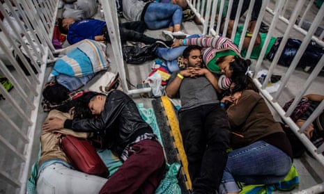 Venezuelan migrants living in Medellin, Colombia sleep as they wait to attend a job fair on 27 September. The United Nations reported that 2.6 million Venezuelans are now living abroad.