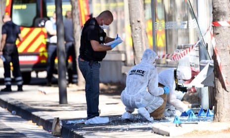 Forensic police examine a bus shelter in Marseille.