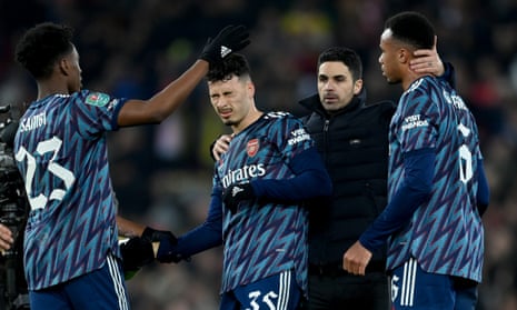 Mikel Arteta congratulates his players after they held on for a 0-0 draw at Anfield in the Carabao Cup semi-final first leg with only 10 men.