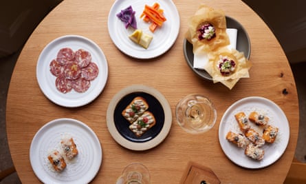 Six artfully designed plates of food on a round table