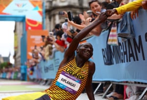Uganda’s Victor Kiplangat bumps fists with a spectator after winning the men’s marathon.