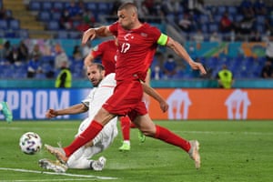 Turkey’s Burak Yilmaz is tackled by Italy’s Giorgio Chiellini.