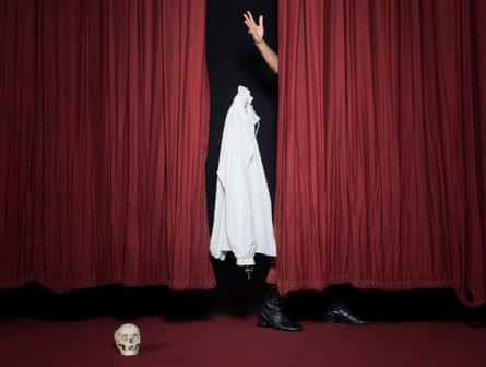 White shirt between red theatre curtains, thrown by Rhik Samadder's hand, with skull on floor in front