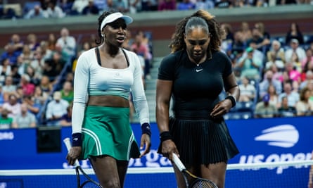 Venus and Serena Williams confer as they play against Lucie Hradecka and Linda Noskova of the Czech Republic at the US Open last night.