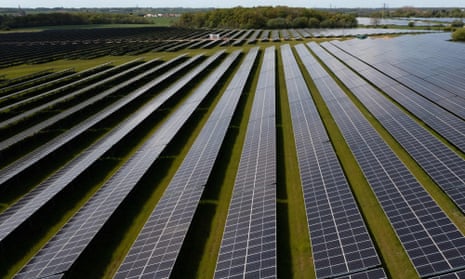 An aerial view shows photovoltaic panels at a solar farm near Thaxted, Essex