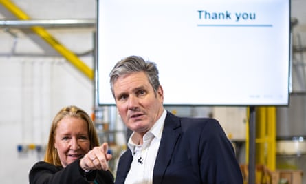 Deborah Mattinson standing alongside Keir Starmer while pointing at something in the distance