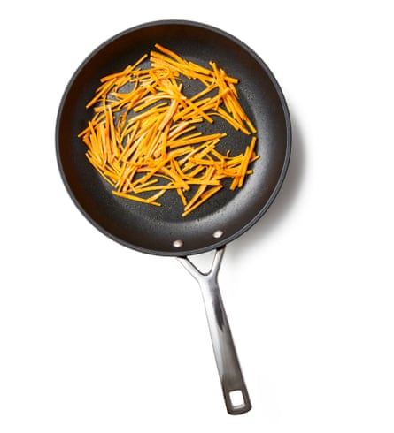 A frying pan of carrots. Put a tablespoon of oil in a frying pan on a medium heat, add the carrots and a pinch of salt, and stir-fry for three to five minutes, until softened. Tip out into a small bowl, add another tablespoon of oil to the pan and repeat with the mushrooms.