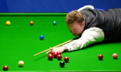 Shaun Murphy, the 2005 champion, plays a red by stretching over the table during his 13-11 victory over Judd Trump.