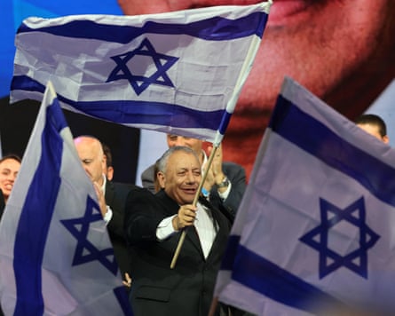 Gadi Eisenkot waves Israel’s national flag at an election night rally.