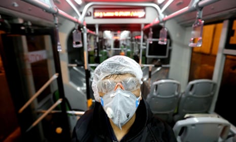 TOPSHOT-IRAN-VIRUS-HEALTH-TRANSPORT<br>TOPSHOT - A Tehran Municipality worker cleans a bus to avoid the spread of the COVID-19 illness on February 26, 2020. - Iran said Tuesday its coronavirus outbreak, the deadliest outside China, had claimed 15 lives and infected nearly 100 others -- including the country’s deputy health minister. The Islamic republic’s neighbours have imposed travel restrictions and strict quarantine measures after reporting their first cases in recent days, mostly in people with links to Iran. (Photo by ATTA KENARE / AFP) (Photo by ATTA KENARE/AFP via Getty Images)