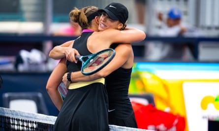 Paula Badosa and Aryna Sabalenka, both dressed in black, embrace at the net after their Miami Open second round match