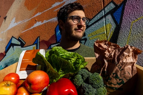 Josh Brooks-Duncan, co-founder of imperfect box delivery company Farmers Pick, carries a box ready for delivery to a customer in Brunswick, Melbourne.