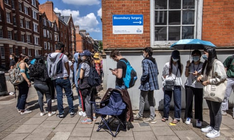 People queue for coronavirus vaccinations at Bloomsbury surgery, London.