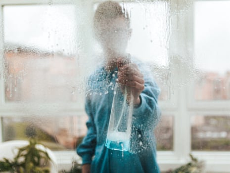anonymous person cleaning window