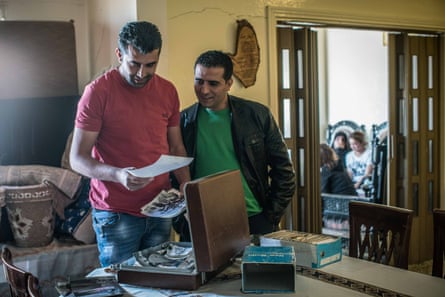 Taraya, Lebanon - Chamran Hamieh [left], Hamza Akel Hamieh’s son, goes through his father’s collection of images from the civil war, stored in old suitcases in his home in the the Bekaa Valley. Hamza Akel became a legend in the Middle East after hijacking six planes between 1979 and 1982 -- a record to this day -- to draw the world’s attention to the kidnapping of Musa Sadr, his religious leader. One of the hijackings, in 1981, was among the longest in aviation history.