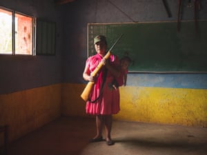 A female member of the community defence force holds her weapon. Since early 2019, the village has been attacked repeatedly by Los Ardillos cartel, prompting residents to take action. Rincón de Chautla, Guerrero, 10 June 2019