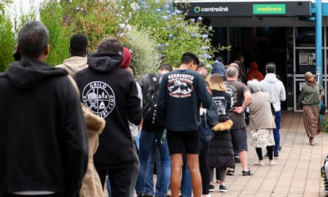 People are seen lining up at Centrelink in Flemington on March 23, 2020 in Melbourne, Australia.