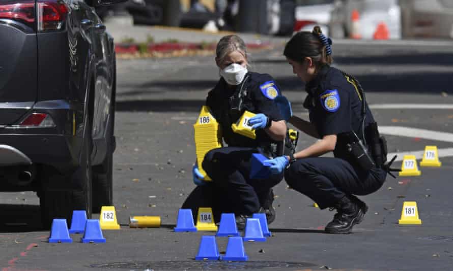 Sacramento Police crime scene investigators place evidence markers on 10th street at the scene of a mass shooting in Sacramento, Calif., on Sunday, April 3, 2022. (Jose Carlos Fajardo/Bay Area News Group via AP)