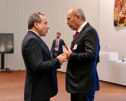Araghchi and Safadi stand facing each other in conversation