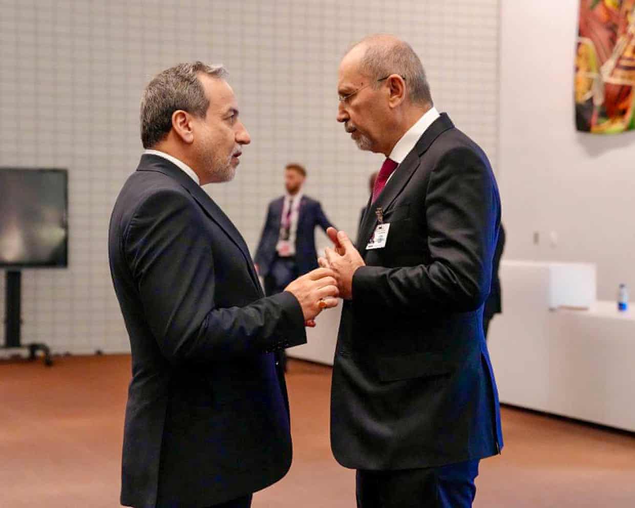 Araghchi and Safadi stand facing each other in conversation