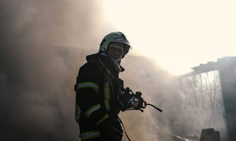 A firefighter at the scene of a Russian attack which targeted energy infrastructure in Kyiv, Ukraine on 18 October.