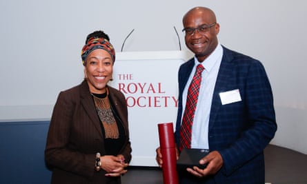 Chibale and Macenje Mazoka standing in front of a sign for the Royal Society