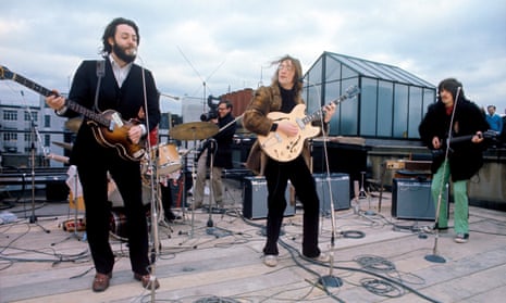 The Beatles play on the rooftop of their Apple Corps HQ.