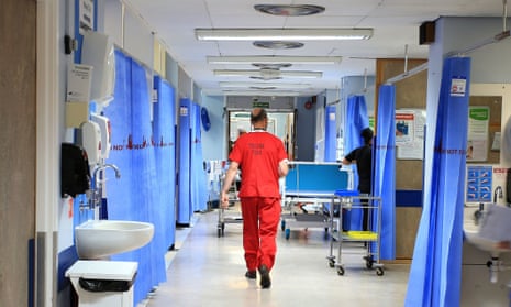 Doctor walking through an NHS ward