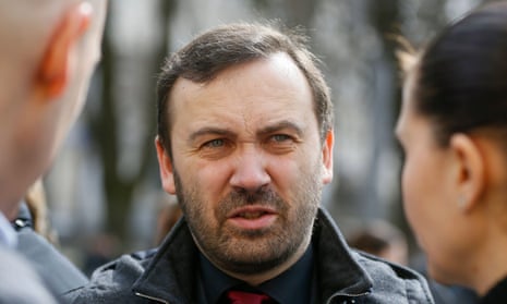 Russian former parliamentarian Ilya Ponomarev speaks with acquaintances after a burial service, part of the funeral of Russian former lawmaker Denis Voronenkov