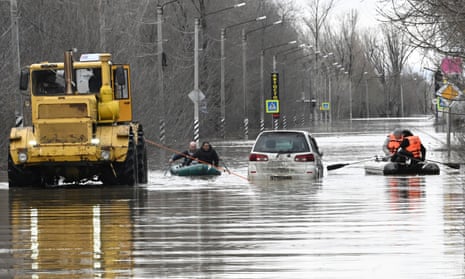 People use rubber boats in a flooded street after part of a dam burst, in Orsk, Russia. S