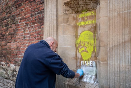 Graffiti reading ‘Eugenics is genocide … Fisher must fall’ being cleaned off Gonville and Caius College in Cambridge University in 2020.