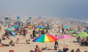 People enjoy the beach amid the novel coronavirus pandemic in Huntington Beach, California on 25 April 2020.