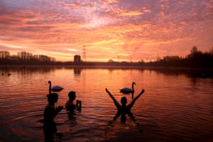 Manchester, UK: a swimmer reacts as the sun rises over Sale Water Park