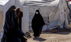 Women walk in Roj detention camp in northeast Syria Wednesday, Feb. 9, 2022. Syrian Kurdish authorities are struggling to supervise tens of thousands of IS-affiliated foreign nationals they are holding in camps and prisons across northeast Syria, with no one to take them. A deadly prison attack last month has sharpened the focus on the detainees' uncertain future. (AP Photo/Baderkhan Ahmad)