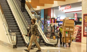 Covid: UK records 44,932 new cases and 145 deaths; US set to partly lift travel restrictions – as it happened 11 People wearing masks are seen in a shopping mall in Canberra, Australia.