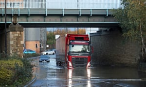 A lorry drives through flood water near Meadowhall shopping centre in Sheffield