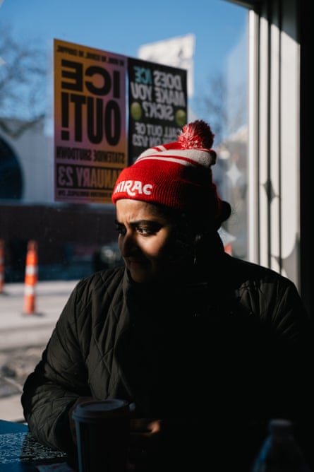 Woman in red beanie sits for a portrait
