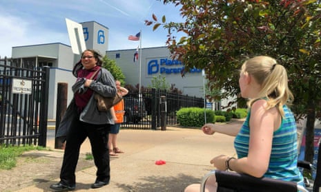 An anti-abortion campaigner addresses a passerby outside the Planned Parenthood clinic in St Louis. The clinic, the last in the state offering abortions, could close this week.