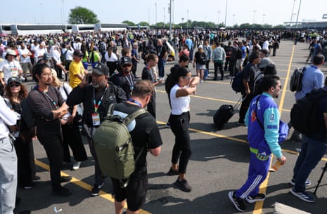 Members of the media and staff queue to enter the stadium before the matc