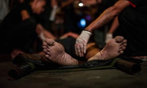 Paramedics attend the scene of an extrajudicial killing in Manila in September