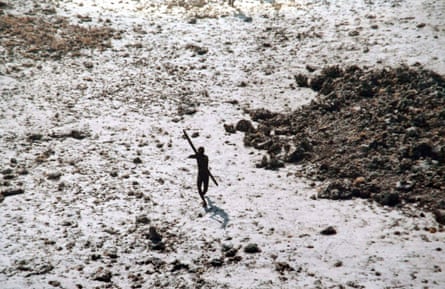 In this handout photo provided by the Indian Coast Guard and Survival International and taken in 2004, a man with the Sentinelese tribe aims his bow and arrow at an Indian Coast Guard helicopter.