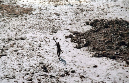 A Sentinelese man aims his bow and arrow at an Indian coast guard helicopter as it flies over North Sentinel Island after the 2004 Indian Ocean tsunami